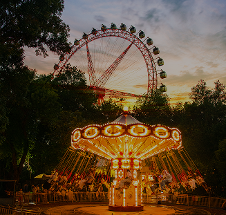 Ferris wheel and carousel against the sunset in Central Park
