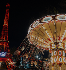 Night view of a carousel and illuminated tower in Central Park