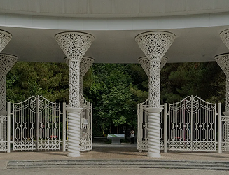 Main entrance gates of Central Park with white columns and arched canopy