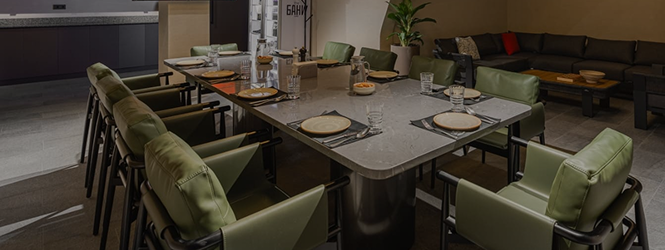 Restaurant hall with a set table and green armchairs