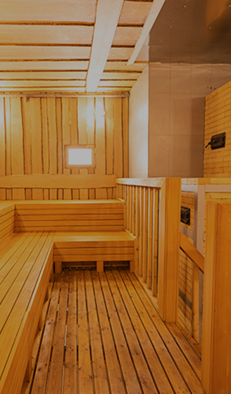 Wooden steam room with benches and soft lighting
