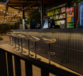 Bar area of the 'More' complex with high stools and ambient lighting