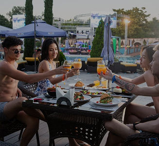 Guests enjoying food and drinks on the poolside terrace at the 'More' complex