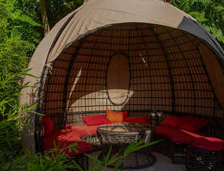 Cozy cabana with sofas in the green relaxation area of the 'More' complex