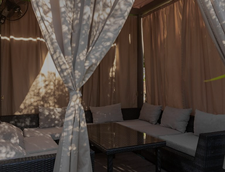 VIP cabana with white curtains and soft furniture for a private retreat at the 'More' complex